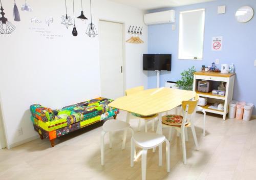 a dining room with a table and chairs and a couch at MARINO1 - Vacation STAY 40074v in Fukuyama