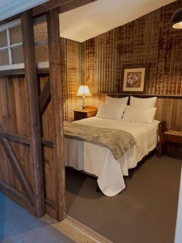 a bedroom with a bed in a room at Charming 1-Bed Farm Cabin with Wood Fire in Tenterfield