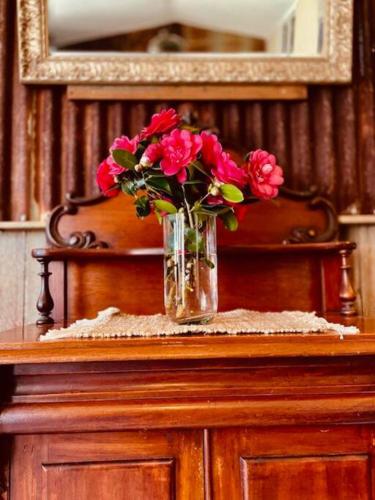 a vase of flowers sitting on top of a table at Charming 1-Bed Farm Cabin with Wood Fire in Tenterfield