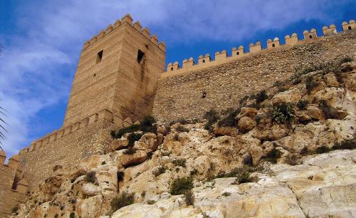 a tall brick building on top of a mountain at Hostal Maribel in Almería