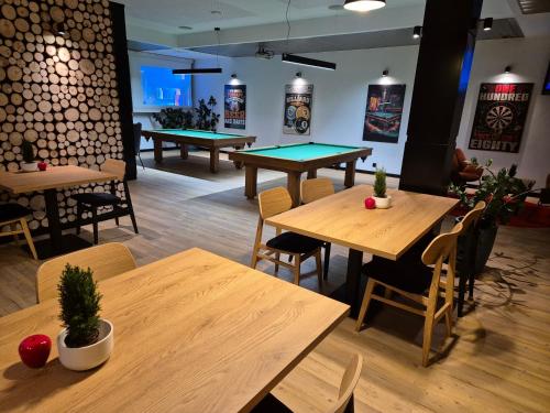 a restaurant with wooden tables and ping pong tables at Hotel Polonez in Kraków