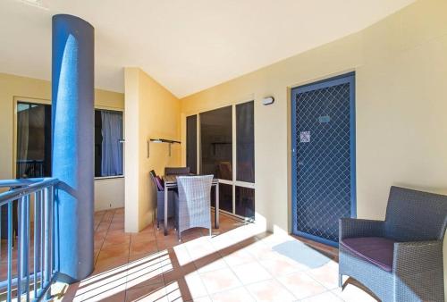 a room with a balcony with a table and chairs at Beachfront Apartments in Port Macquarie
