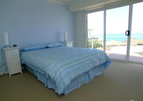 a bedroom with a bed with a view of the ocean at Elanora Tranquility at Emu Bay in Emu Bay