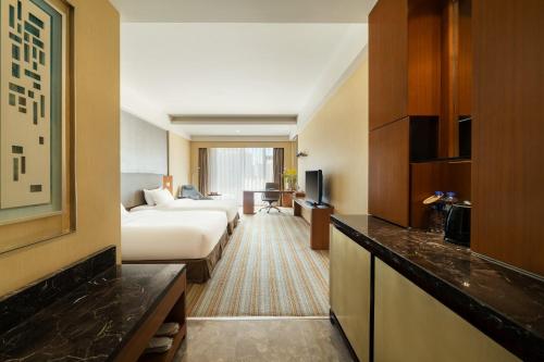 Postel nebo postele na pokoji v ubytování Juntai Hotel Xiamen