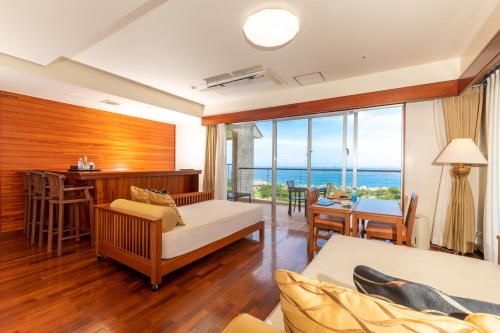 a living room with a view of the ocean at Kanucha Bay Hotel & Villas in Nago