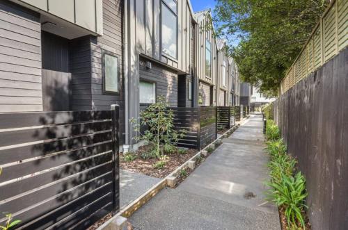 a sidewalk next to a row of houses at Sanctuary in St Albans Chic 2-Bedroom Retreat in Christchurch