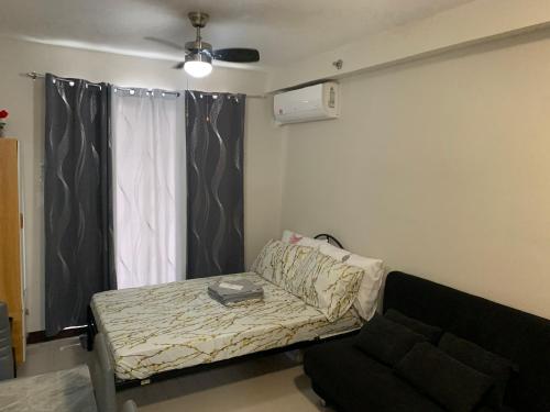 a living room with a couch and a window at RF Condotel in Lapu Lapu City