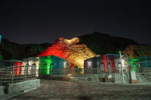 a building that is lit up at night at Dibba Mountain Park Resort in Fujairah
