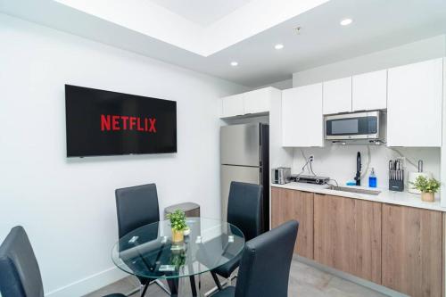 a kitchen with a glass table and chairs in a kitchen at Stylish Studio Miami Suite Oasis Near Calle Ocho & Brickell in Miami