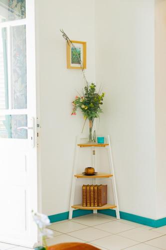 a ladder with a vase on it with a plant at Le chant du Lagon in La Saline les Bains