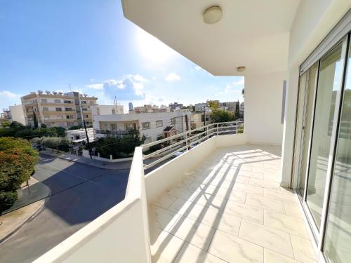 a balcony with a view of a city at Samos City Center, 2BR Sleeps 4 in Limassol