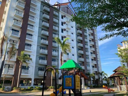 a playground in front of a large building at Modern Condo, Sea View, Fast Wifi, Cafe, Panglao in Dauis