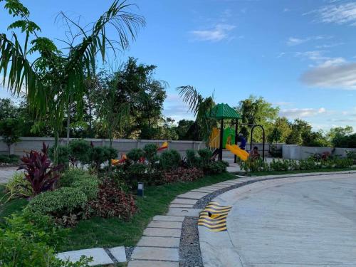 a playground in a park with a slide at Modern Condo, Sea View, Fast Wifi, Cafe, Panglao in Dauis