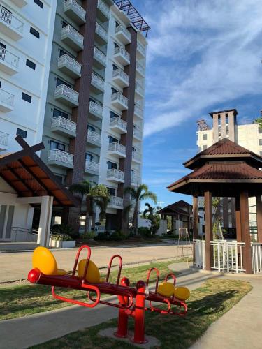a playground in front of a large apartment building at Modern Condo, Sea View, Fast Wifi, Cafe, Panglao in Dauis