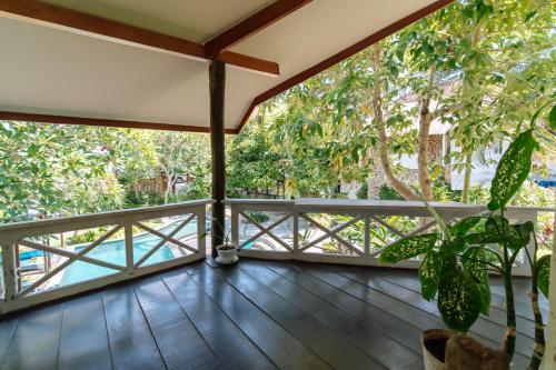 a balcony with a view of the trees at The Onion Collective in Ubud