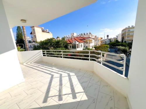 a balcony with white railing and a view of a city at Samos City Center, 2BR Sleeps 4 in Limassol