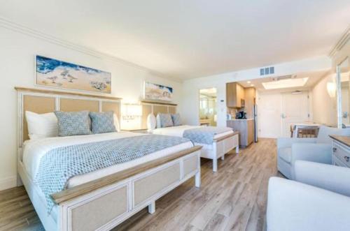 a hotel room with a bed and a couch at Sanibel Inn in Sanibel