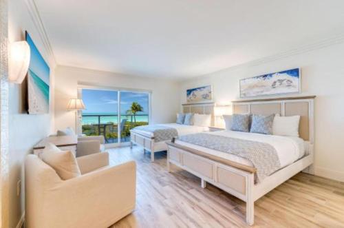 a bedroom with two beds and a living room at Sanibel Inn in Sanibel