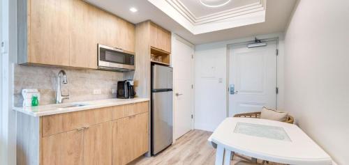 a small kitchen with a sink and a refrigerator at Sanibel Inn in Sanibel