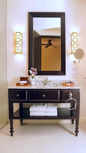 a bathroom with a sink and a large mirror at Galle Face Hotel in Colombo