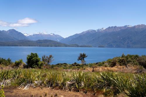 a view of a lake with mountains in the background at Tukare Lookout in Te Anau