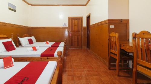 a hotel room with two beds and a desk at RedDoorz @ Sagada Sunrise View Homestay in Sagada