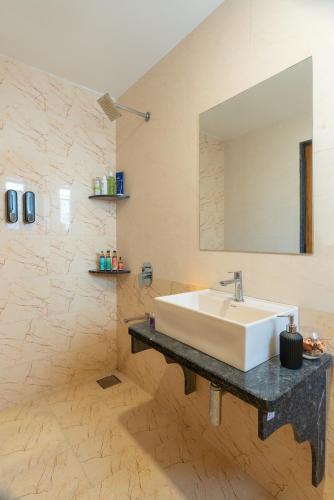 a bathroom with a sink and a mirror at Thalaiva Villa by Hillstayion in Panchgani
