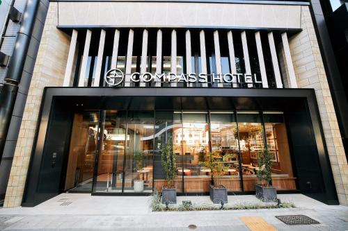 a store front of a building with a sign on it at Compass Hotel Nagoya in Nagoya