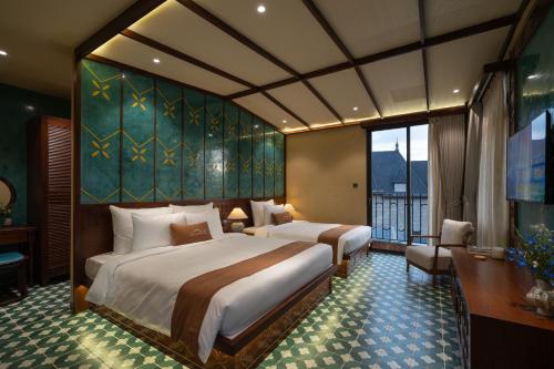 a bedroom with two beds and a large window at The Mist Boutique DaLat Hotel in Da Lat