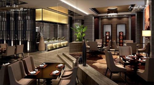 a restaurant with tables and chairs in a room at Proud Way Hotel Shenzhen, Kingkey 100 Shopping Mall in Shenzhen