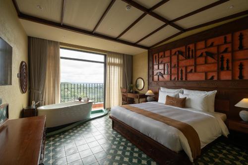 a hotel room with a bed and a bath tub at The Mist Boutique DaLat Hotel in Da Lat