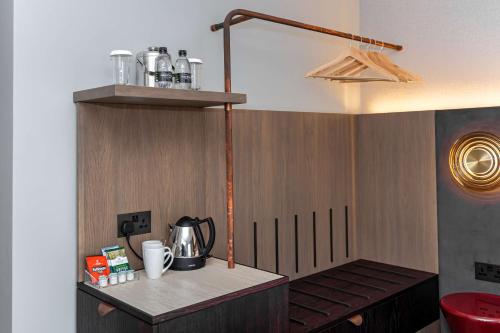 a kitchen with a counter with a tea kettle on it at DoubleTree by Hilton Hotel London - Tower of London in London