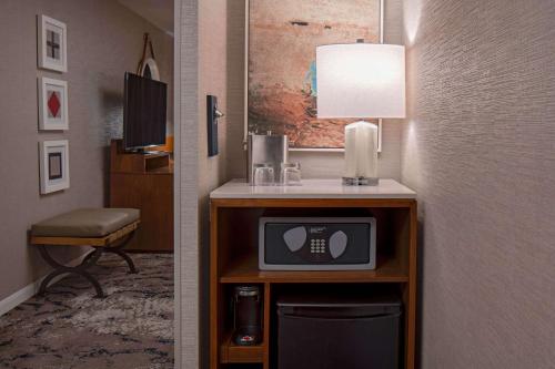 a room with a desk with a tv and a lamp at Hyatt Regency Mission Bay Spa and Marina in San Diego