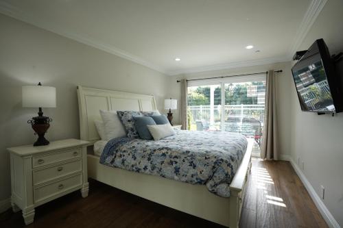 a bedroom with a bed with a dresser and a window at Destination #01 in Anaheim