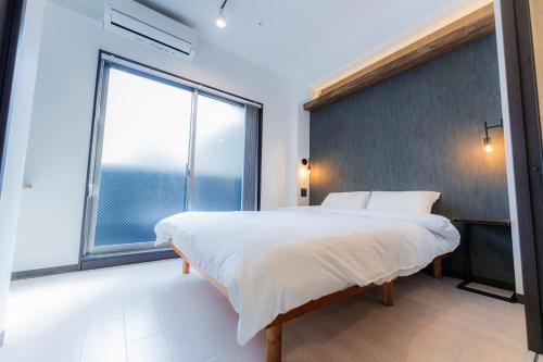 Ένα ή περισσότερα κρεβάτια σε δωμάτιο στο Apartment Hotel MODISH Gion