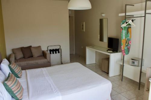 a living room with a bed and a couch at Notos Luxury Studios in Katelios