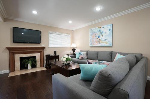 a living room with a couch and a fireplace at Destination #19 in Anaheim
