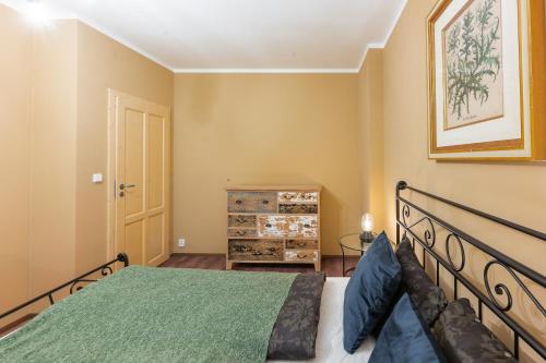 a bedroom with a bed and a dresser at Apartmány za Královskou mincovnou in Jáchymov