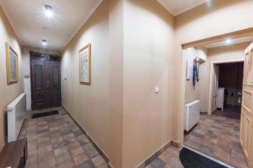 a hallway with a black door and a tile floor at Apartmány za Královskou mincovnou in Jáchymov