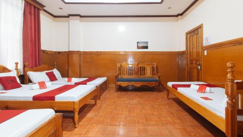 a room with four beds and a crib in it at RedDoorz @ Sagada Sunrise View Homestay in Sagada