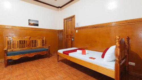 a bedroom with two beds and a wooden wall at RedDoorz @ Sagada Sunrise View Homestay in Sagada