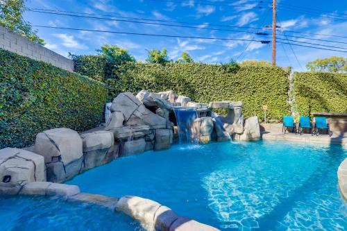 a water slide in a pool with a waterfall at Destination #48 in Placentia