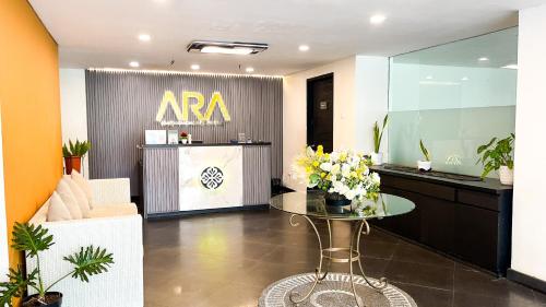 a room with a table with flowers on it at Hotel ARA Legian in Legian