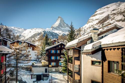 a view of a resort with a snow covered mountain at Jolimont Apartments in Zermatt
