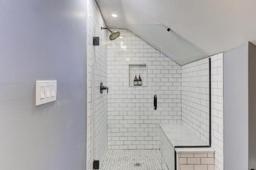 a bathroom with a shower with white tiles at Hideaway Retreat in the Heart of Cooper Young in Memphis