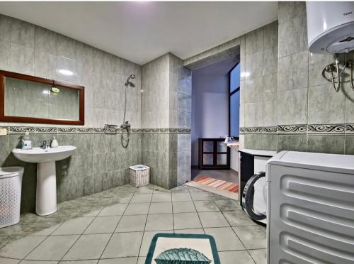 a bathroom with a sink and a shower and a toilet at Rita Apartment in Tirana centre in Tirana