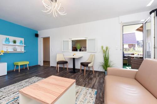 a living room with a couch and a table at Haus zur Möwe FeWo Möwe 2 in Bensersiel