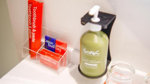 a bottle of mouth wash next to a bottle of soap at Citichic Sukhumvit 13 by Compass Hospitality - Newly Renovated in Bangkok