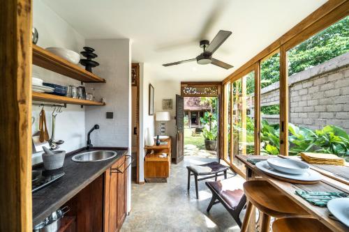 a kitchen with a sink and a large window at Salty Siesta Stays in Selong Belanak
