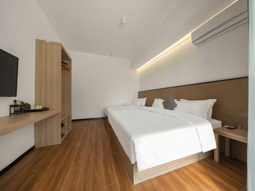 Katil atau katil-katil dalam bilik di Xiamen Wujing Mountain and Sea View Hotel